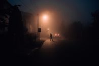 Silhouette of Person Walking on Sidewalk during Sunset