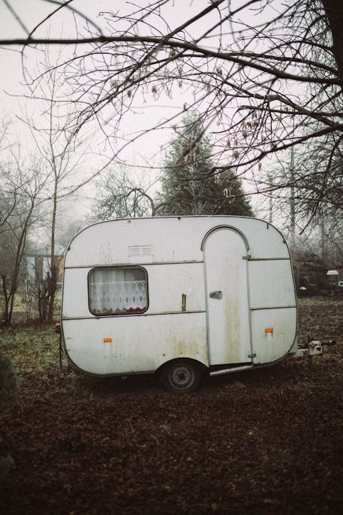 White Vintage Caravan Parked on Grass Field