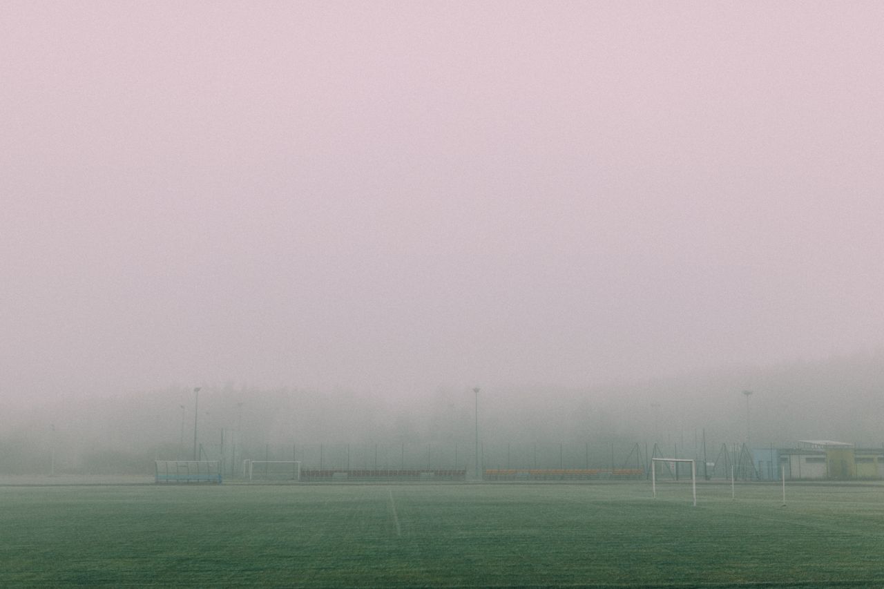 a foggy football field with goals visible creating a serene and moody