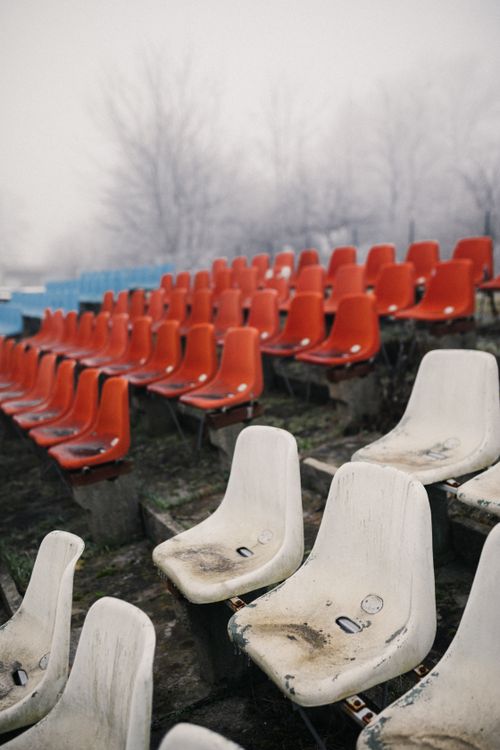 Free Empty stadium seats in foggy, winter setting depict abandonment and decay. Stock Photo