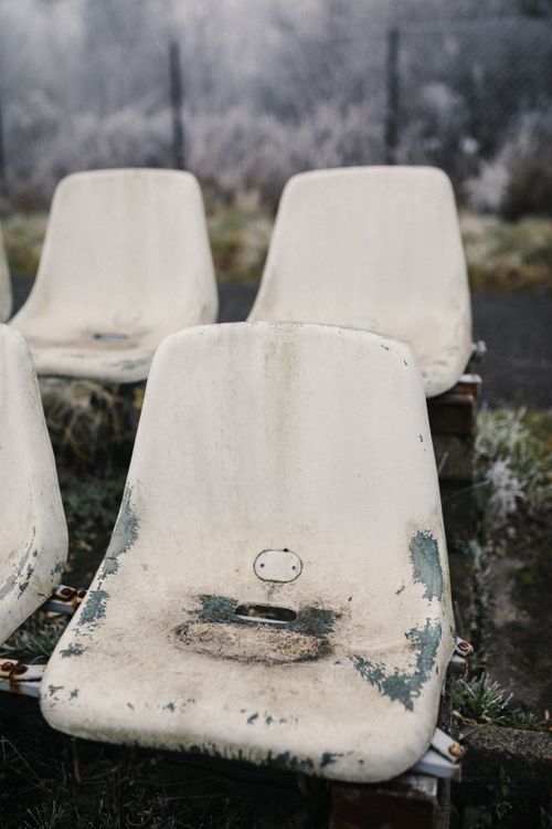 Free Frost-covered empty plastic bleachers in a sportsground during winter. Stock Photo
