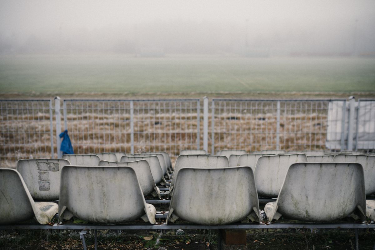 Misty grandstand above an empty pitch — photo by KoolShooters on Pexels