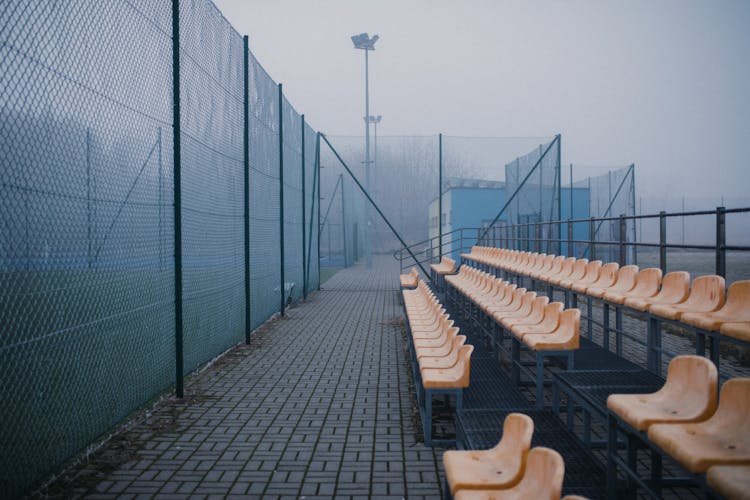 Empty Bleacher Seats In A Football Stadium