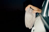 Person Holding White Textile during Night Time