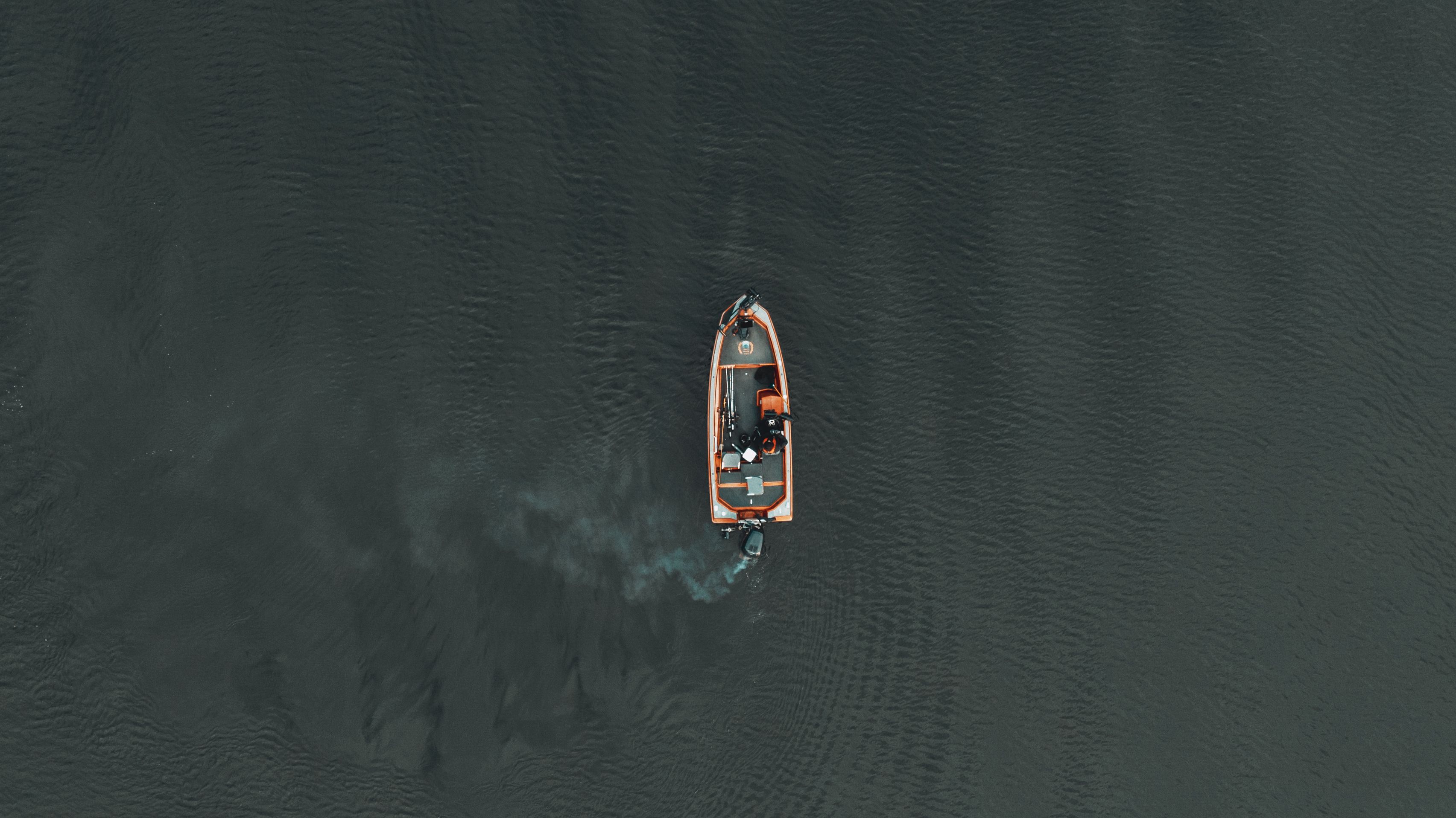 Motorboat sailing on wavy sea in daytime · Free Stock Photo