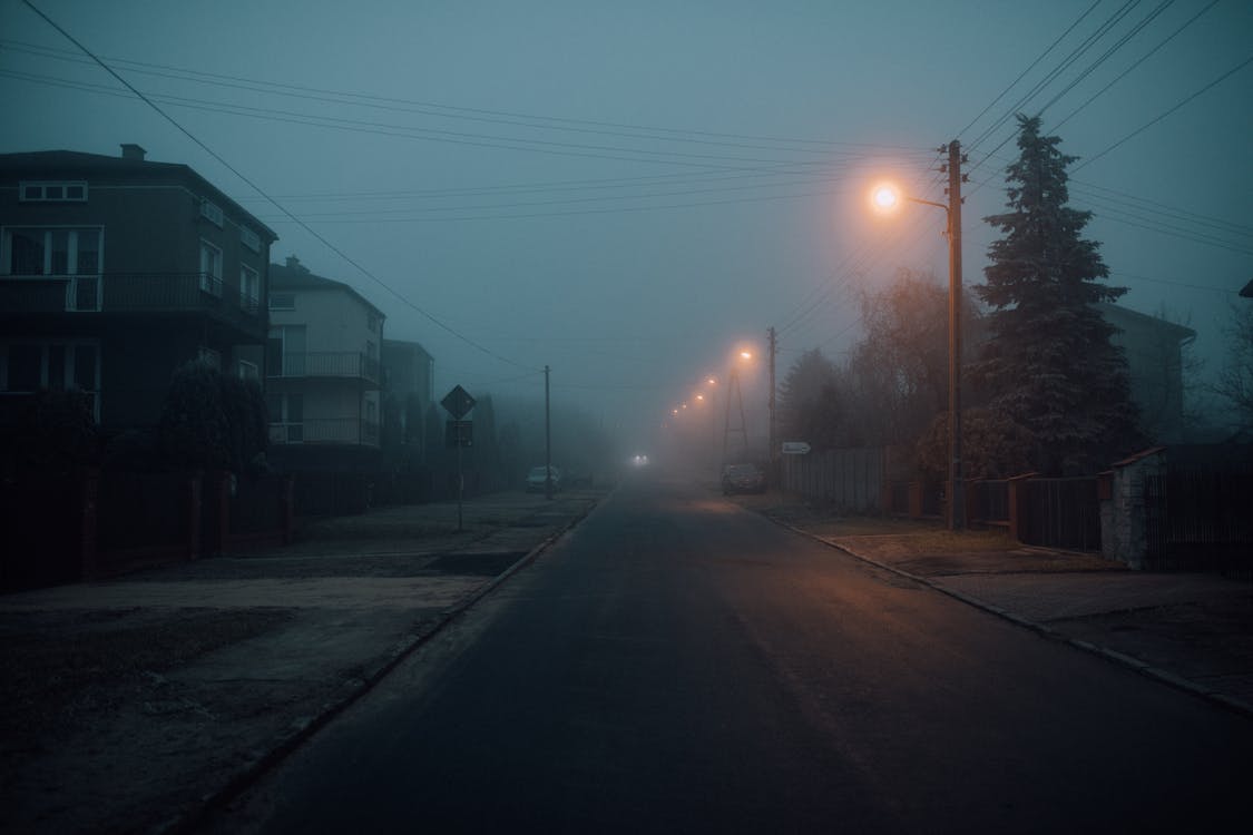 Foggy Street of a Town During Night Time