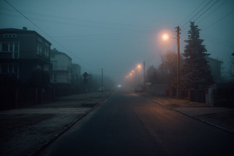 Foggy Street Of A Town During Night Time