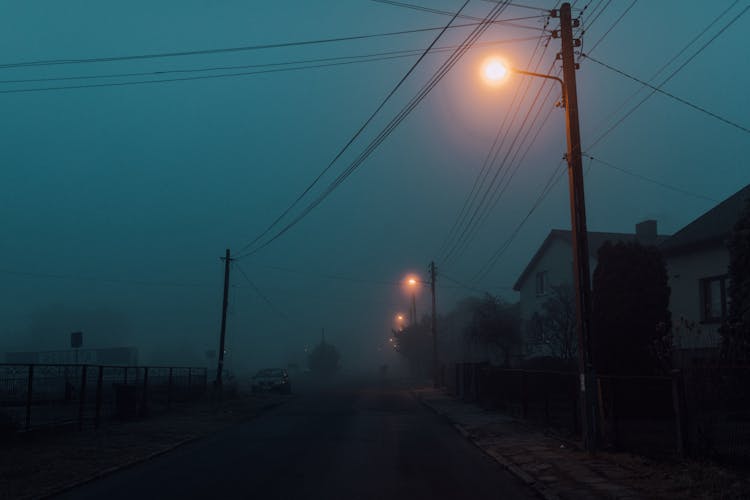 Foggy Street Of A Town With Power Lines