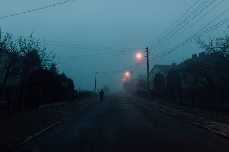 Silhouette Of Person Walking On The Street