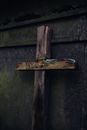 A Broken Wooden Crucifix Leaning on Concrete