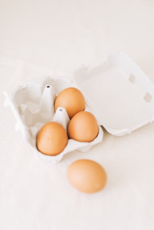 Free Brown Eggs on White Textile Stock Photo