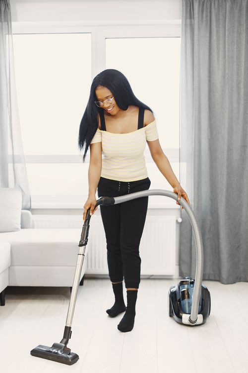 A Woman Using a Vacuum Cleaner to Clean the Floor · Free Stock Photo