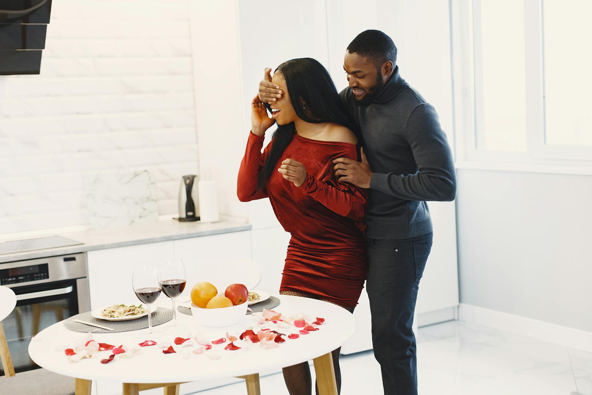 Man Surprising Woman in Kitchen