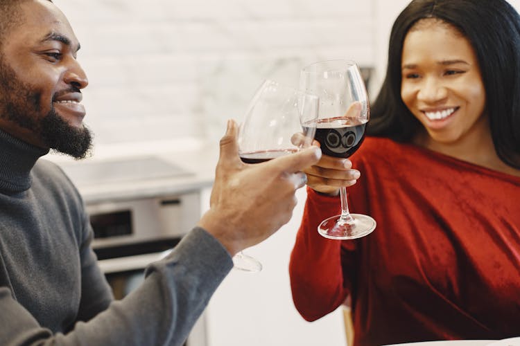 Man And Woman Making A Toast With A Red Wine