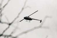 Helicopter flying in light sky in daytime