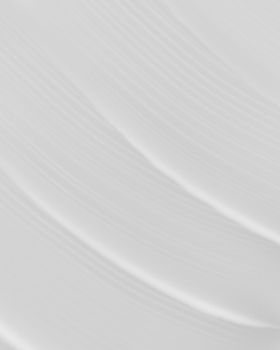 Smooth and textured white cream showing artistic patterns in a close-up view.