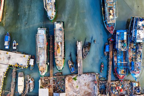Free Explore the bustling fishing harbor in Jakarta with ships and piers from above. Stock Photo