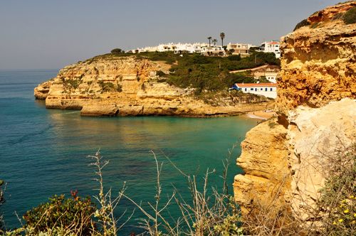 Free Stunning coastal cliffs and turquoise waters at Armação de Pêra, Algarve, Portugal. Stock Photo