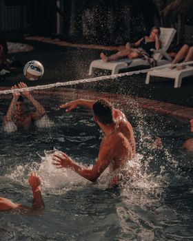 Energetic volleyball match at a poolside in Surfers Paradise with friends enjoying summer fun.