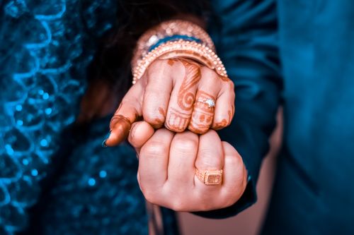 Free Close-up of clasped hands adorned with henna and jewelry, symbolizing a cultural ceremony. Stock Photo