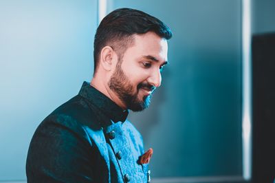 Portrait of a bearded man smiling in formal attire