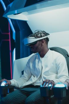 A man wearing a VR headset experiences an immersive virtual reality game indoors.