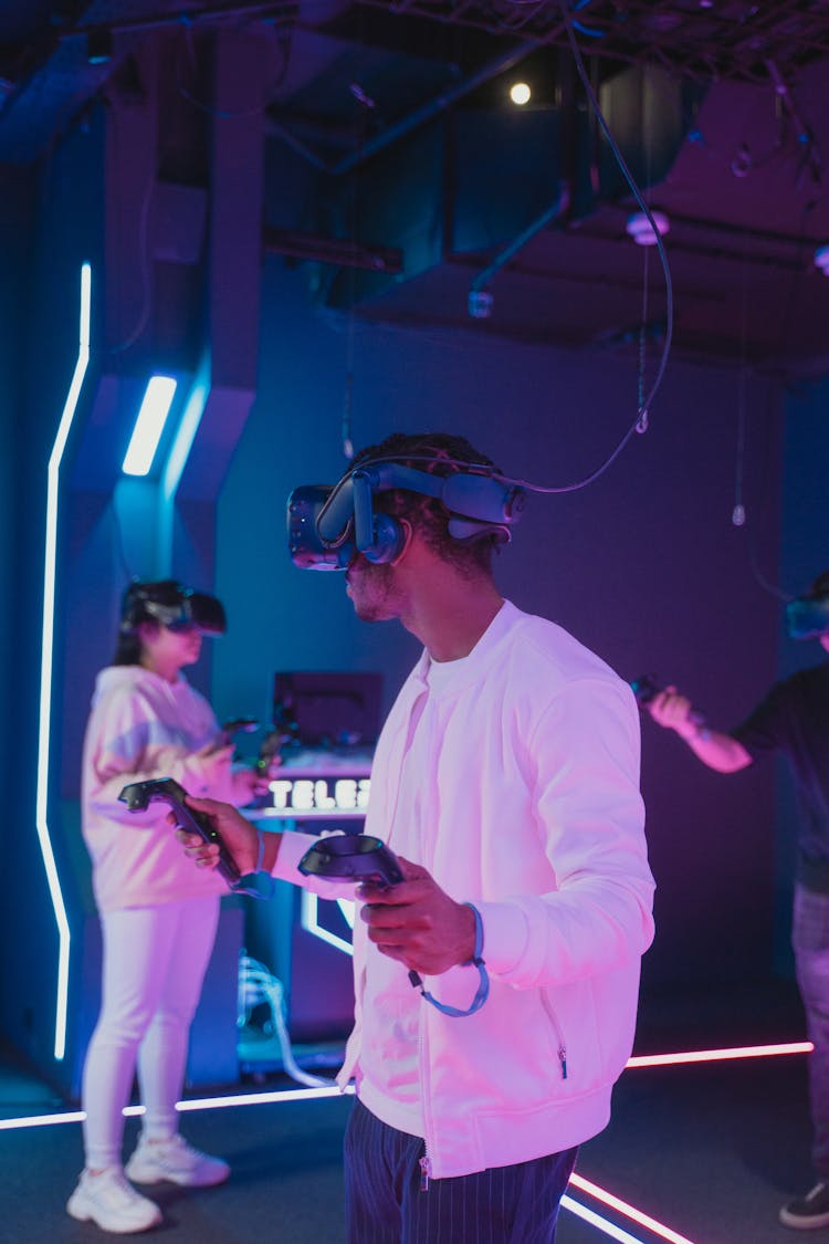 People Playing Video Games While Wearing VR Headsets