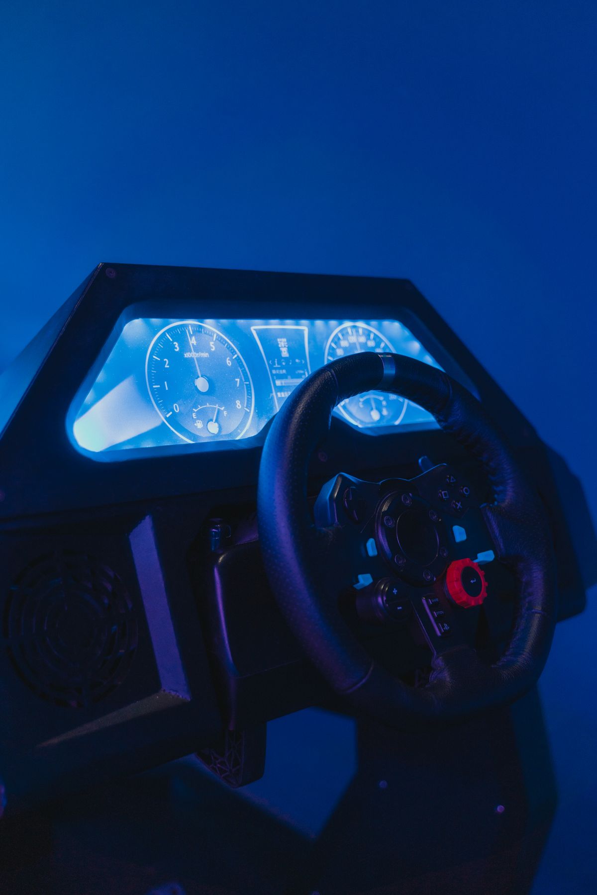 High-tech racing simulator with steering wheel and illuminated controls