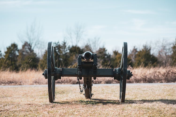 An Antique Cannon On A Field