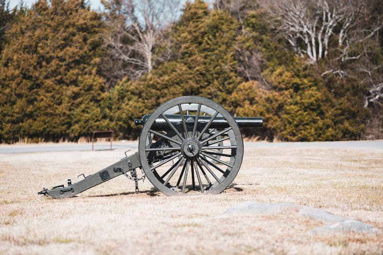 An Antique Cannon On A Field