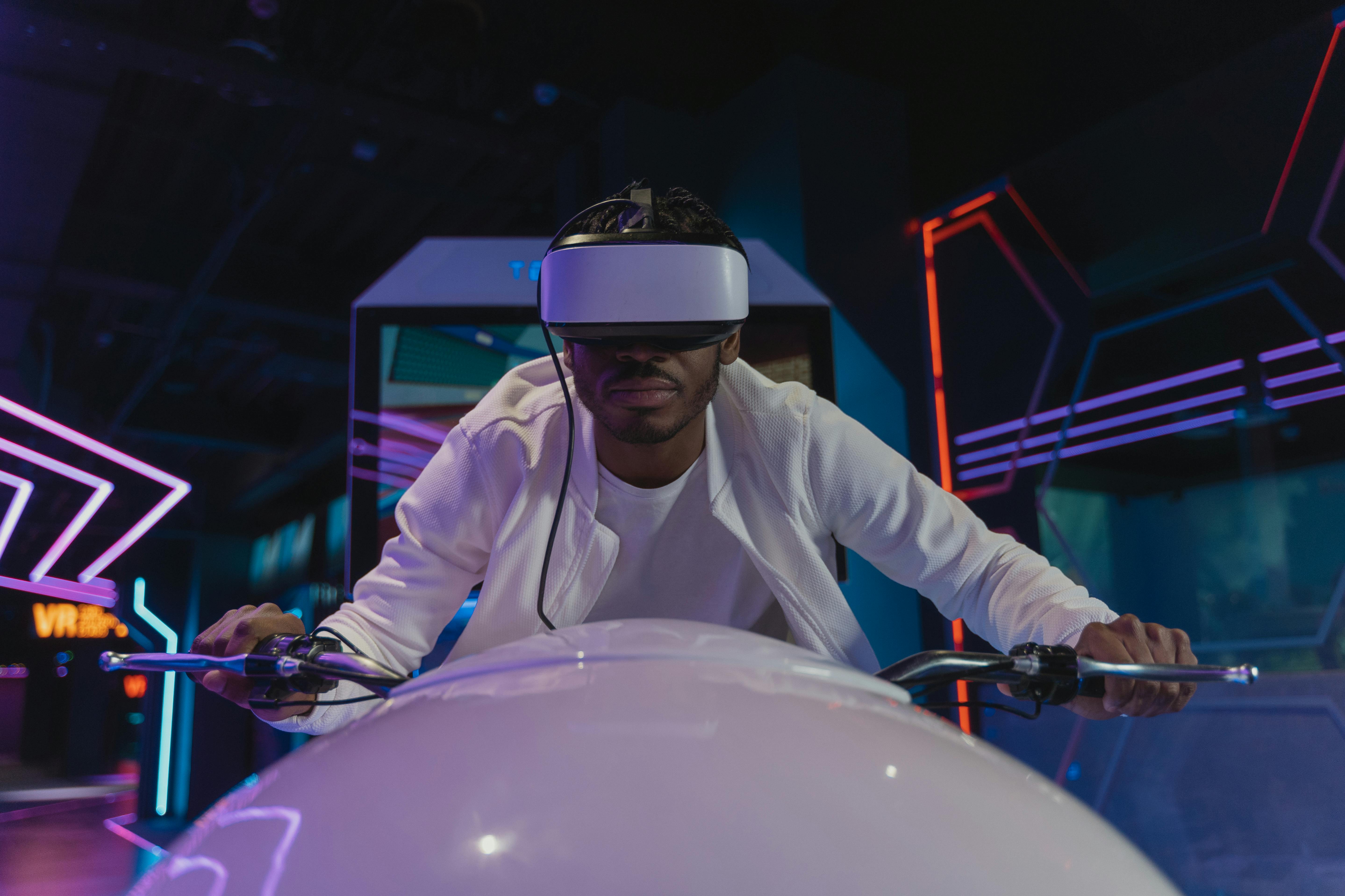 a man in a simulation of riding a motorcycle with a vr headset