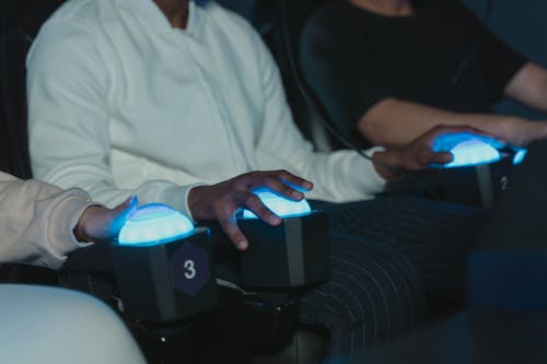 People Sitting on Virtual Reality Simulator