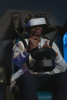 Adult man engaging with virtual reality technology using a headset and joystick indoors.
