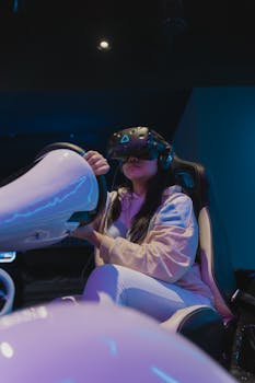 A woman indulges in a virtual reality gaming session wearing VR glasses and a white hoodie indoors.