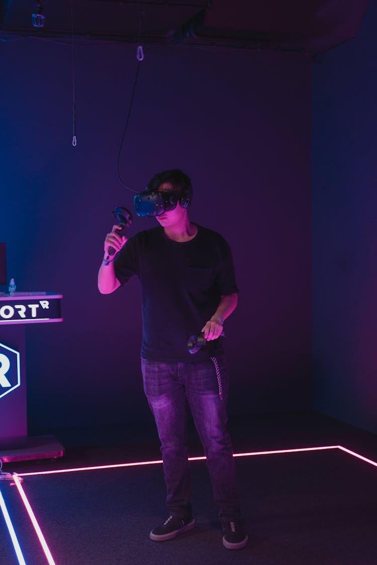 A Man Wearing VR Glasses While Holding A Controller