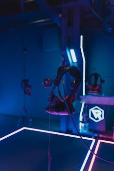 A high-tech virtual reality gaming setup with hanging VR headsets illuminated by neon lights.