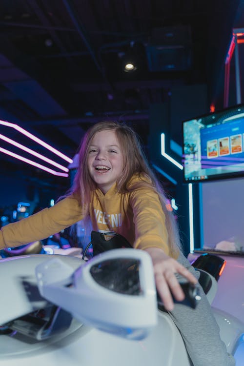 Smiling Girl Riding a Virtual Reality Ride