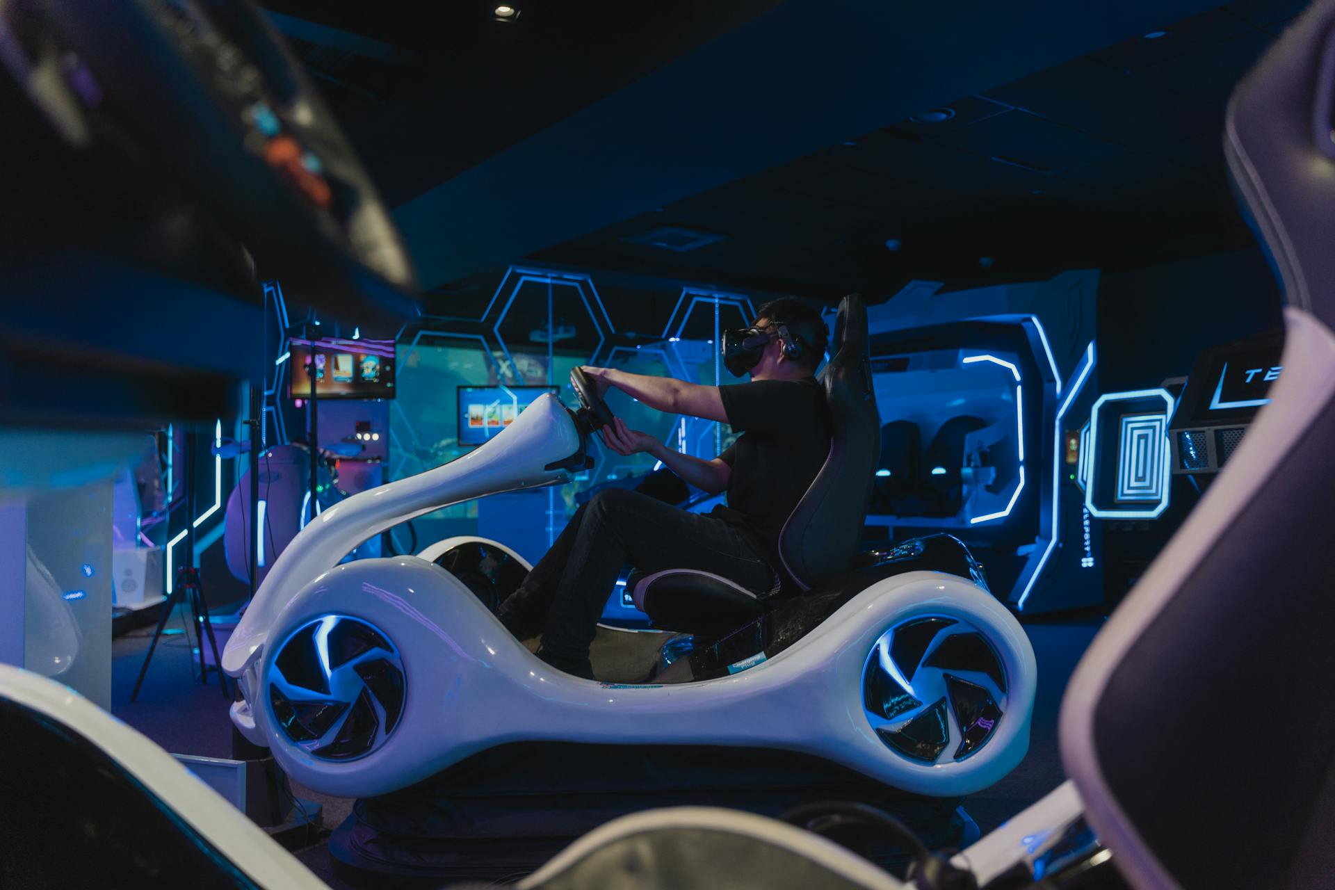 Experience the thrill of riding with a VR motorbike simulator in a futuristic gaming arcade.