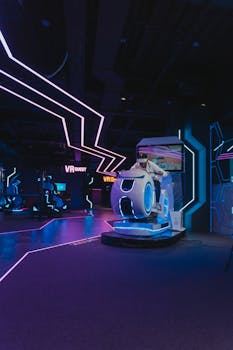 Person enjoying a VR motorbike simulator ride indoors at night.
