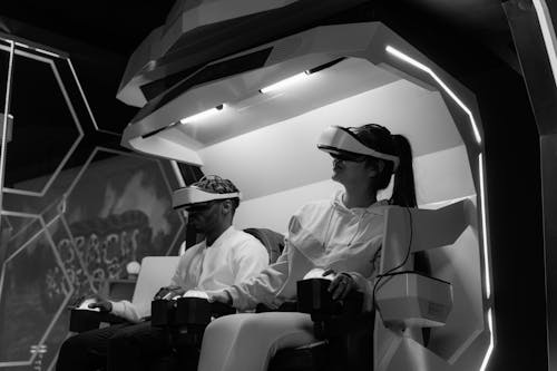 Grayscale Photo of Two People Playing Virtual Reality Glasses