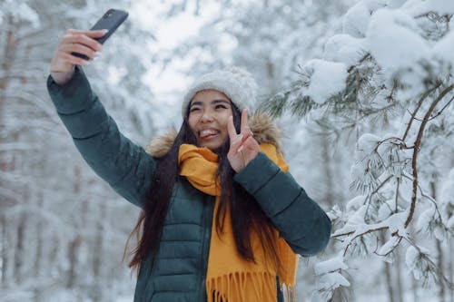 Woman in Winter Clothes Taking Selfie