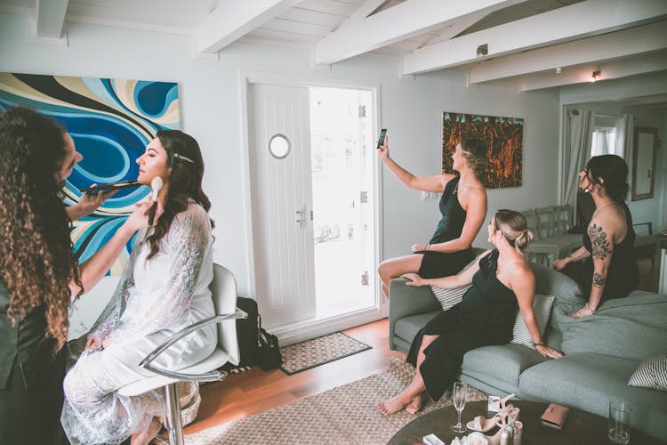 Bridesmaids Taking Selfie During Wedding Preparations