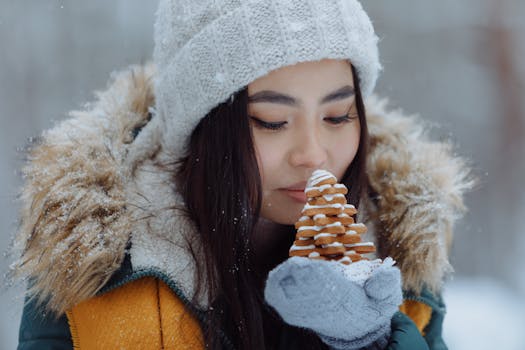 Close-up of a woman savoring the scent of Christmas cookies in winter attire.