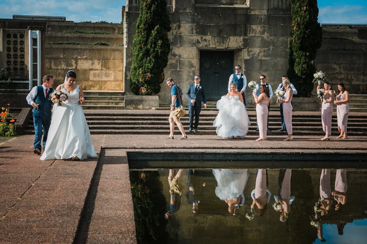 Wedding Couples With Guests On Street