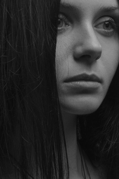 Free Emotive black-and-white portrait of a woman with a serious gaze, shot in Kyiv. Stock Photo