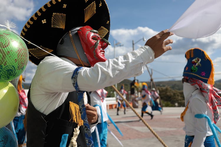 A Person In A Red Mask Dancing