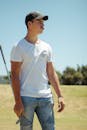 Man with golf club in field