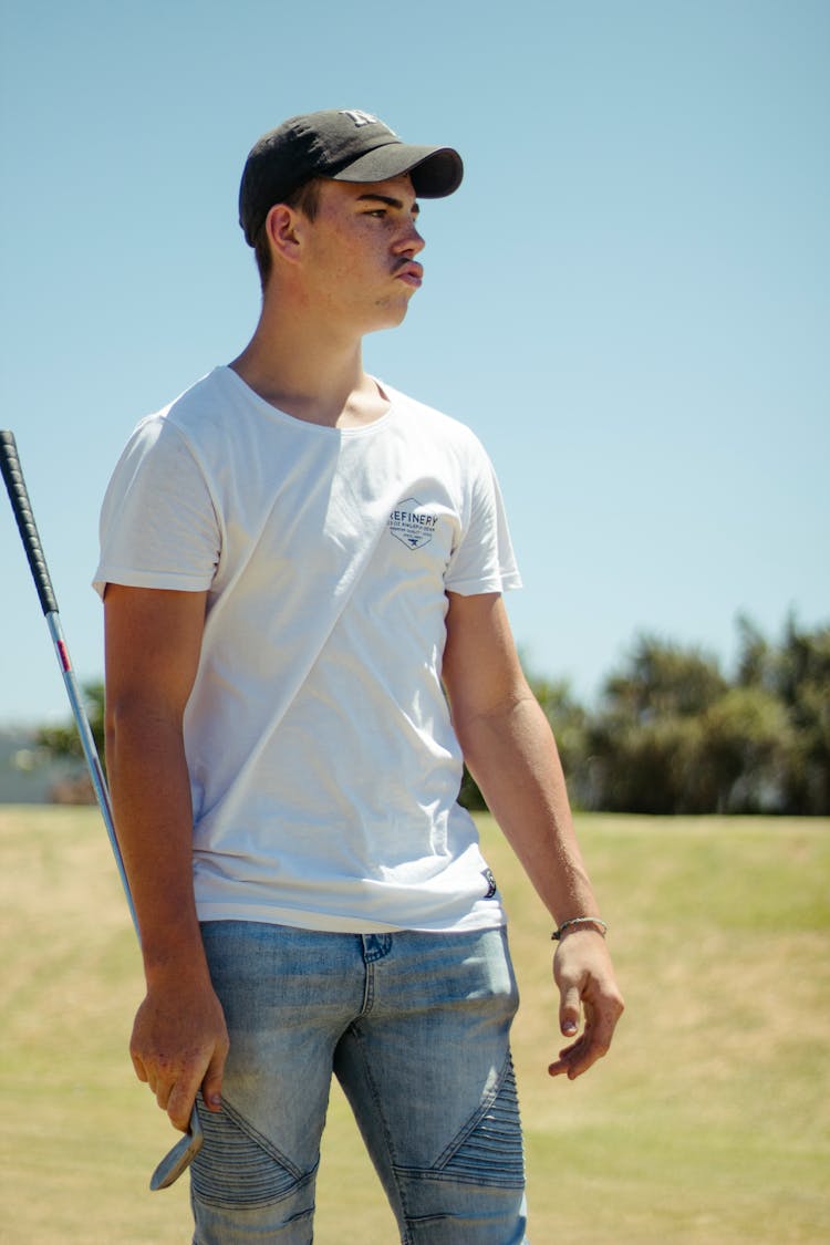 Man With Golf Club In Field