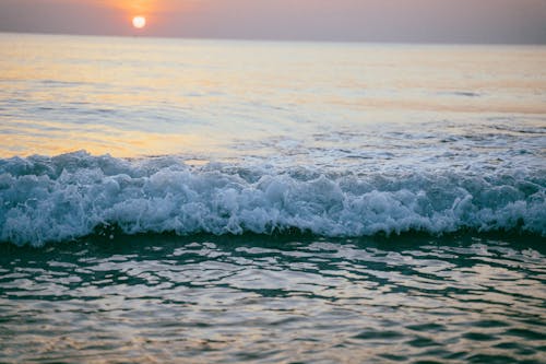 Waves Crashing on the Shore during Sunset