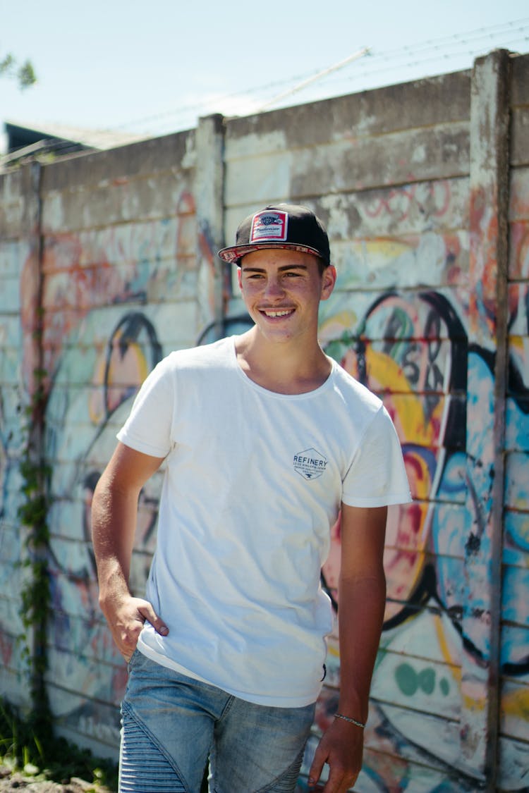 Cheerful Young Man In Cap And Casual Outfit